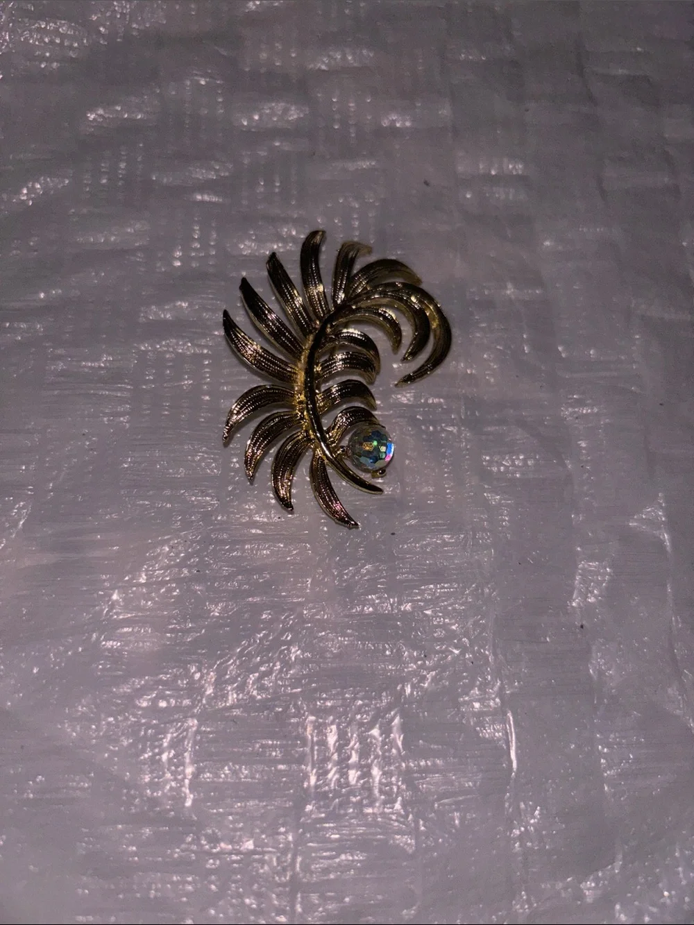 Gold Tone Floral Swirl Brooch with Iridescent Crystal